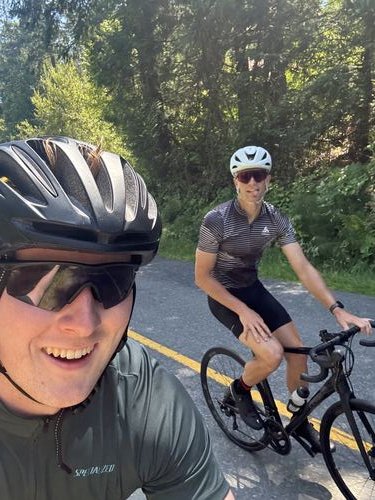 Ezrah and a friend taking a selfie on a road bike ride