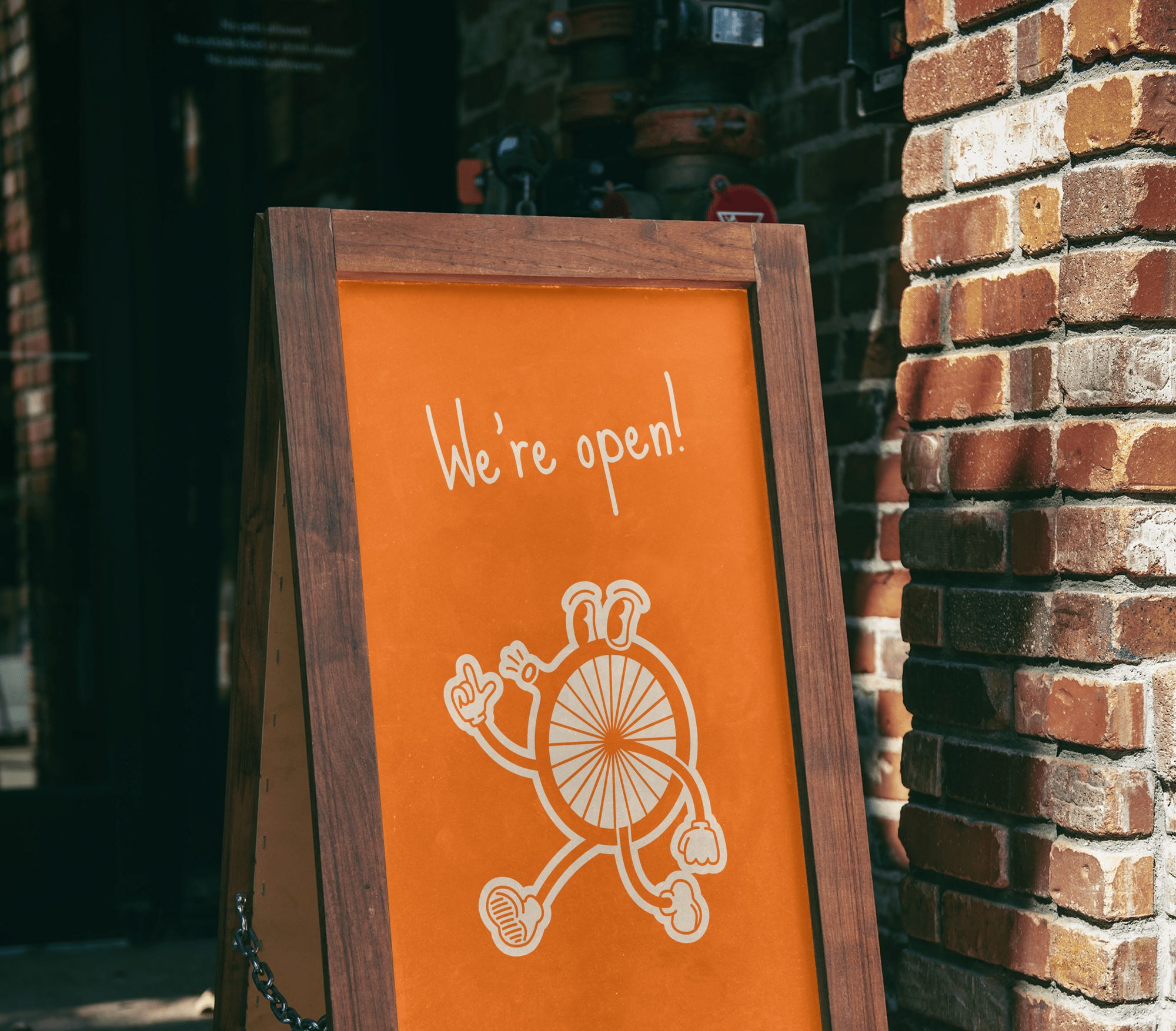 A sandwich board reading &ldquo;We&rsquo;re open!&rdquo; outside Kirk&rsquo;s Bike Shop